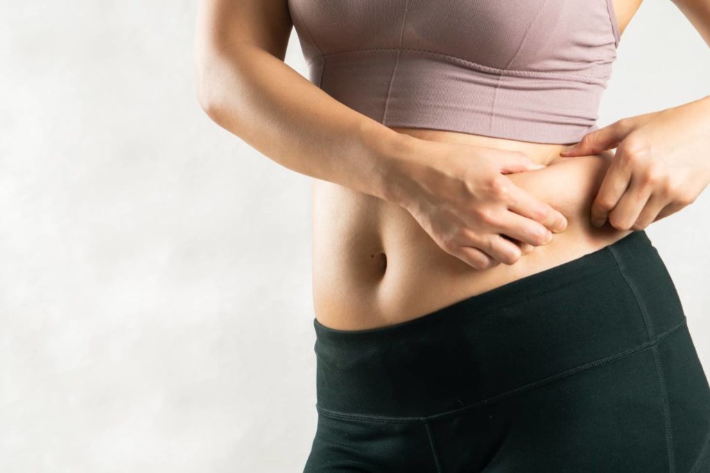 Woman Pinching her Belly | Walnut Creek Aesthetics in Walnut Creek, CA